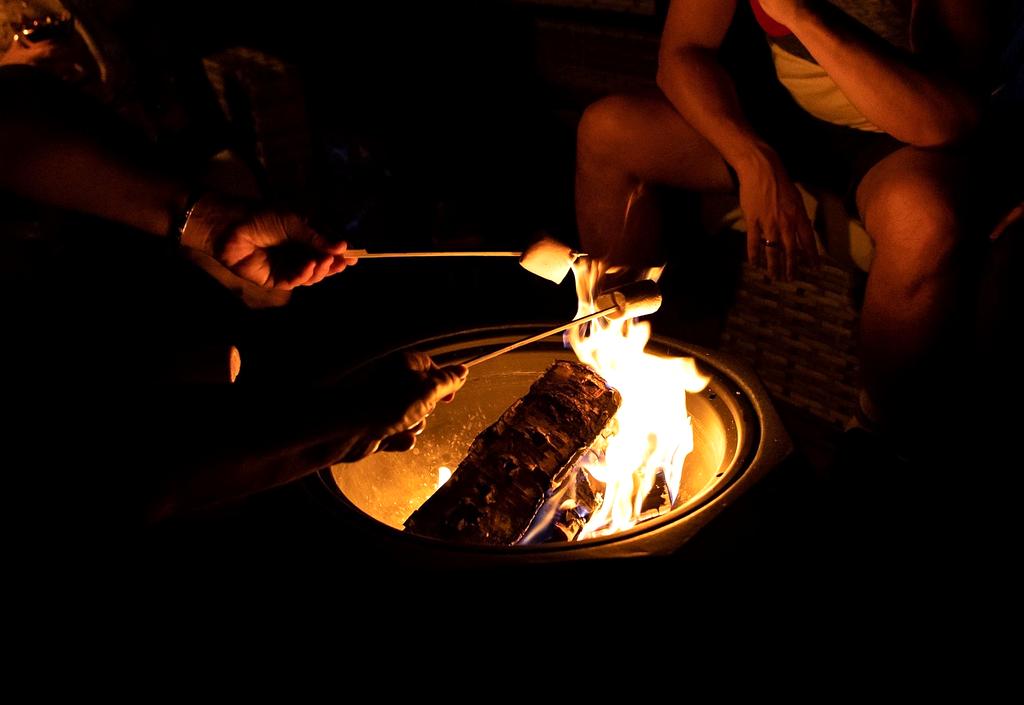 Father teaching daughter to use a camera on a mountain peak